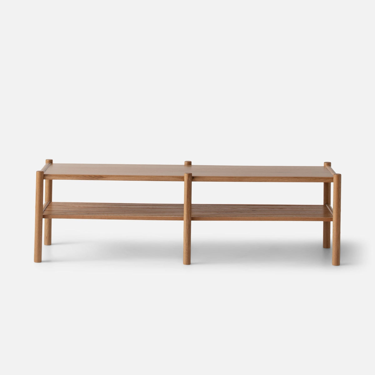 Front view of the Nora Storage Bench showcasing its oak frame and slatted lower shelf on a white background