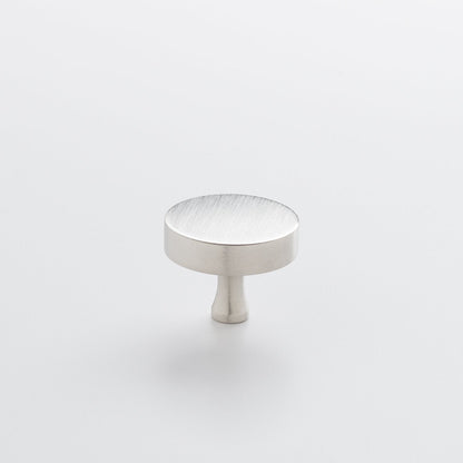 Three-quarter view of the Satin Nickel Riverwood Knob showcasing its flat round top and fluted neck on a light background