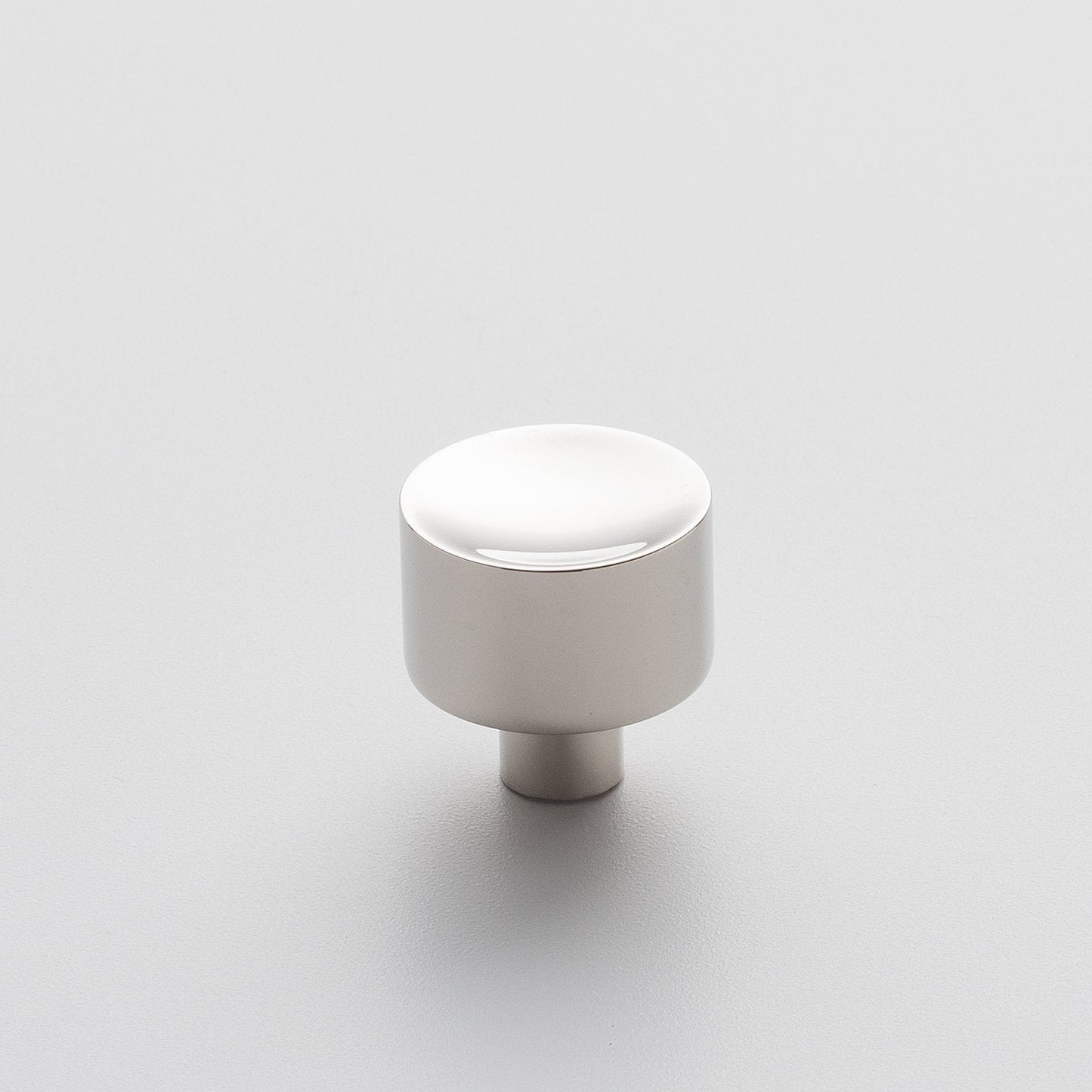 Front view of Mid Century Knob showcasing its cylindrical shape with a white finish on a light background