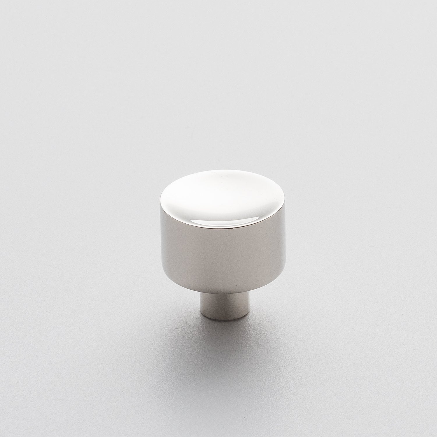 Front view of Mid Century Knob showcasing its cylindrical shape with a white finish on a light background