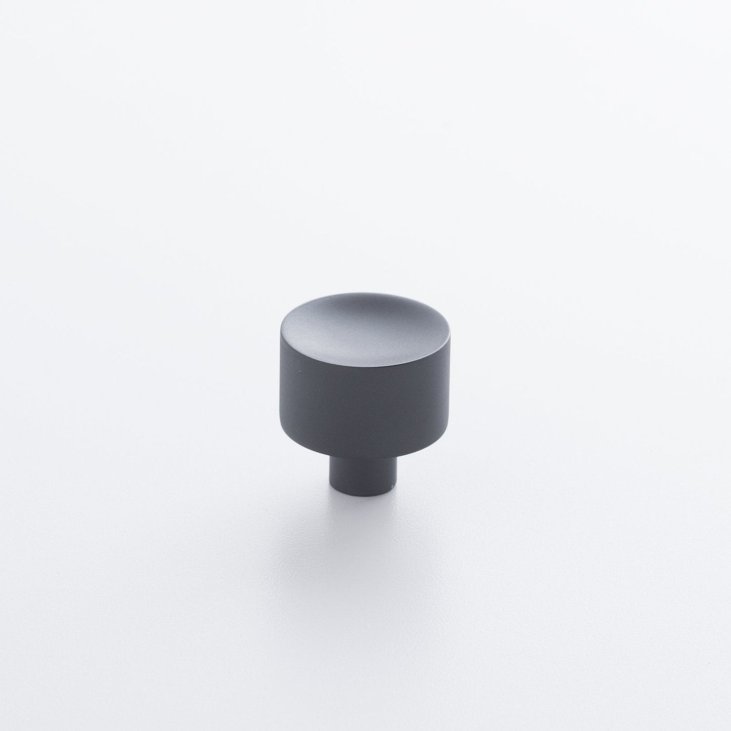 Angled view of Mid Century Knob showcasing its cylindrical shape and short base on a white background