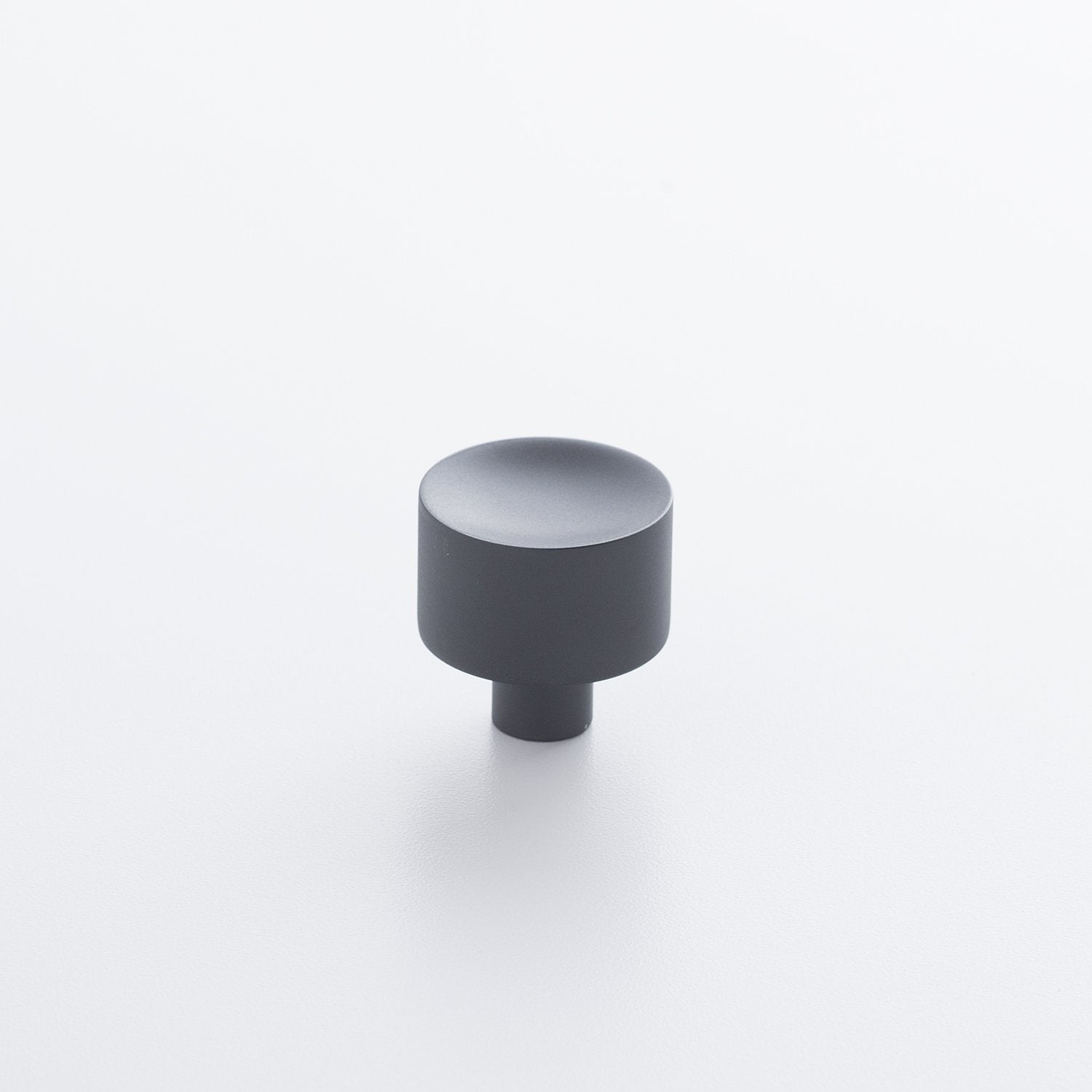 Angled view of Mid Century Knob showcasing its cylindrical shape and short base on a white background
