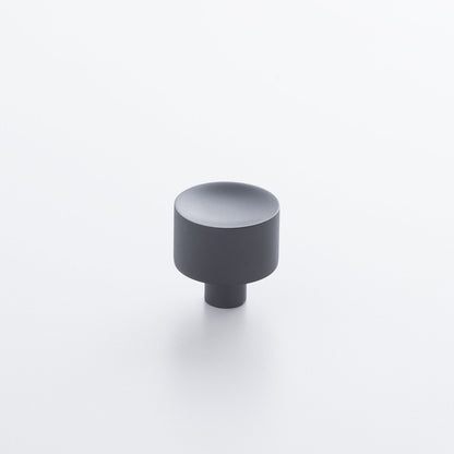 Angled view of Mid Century Knob showcasing its cylindrical shape and short base on a white background