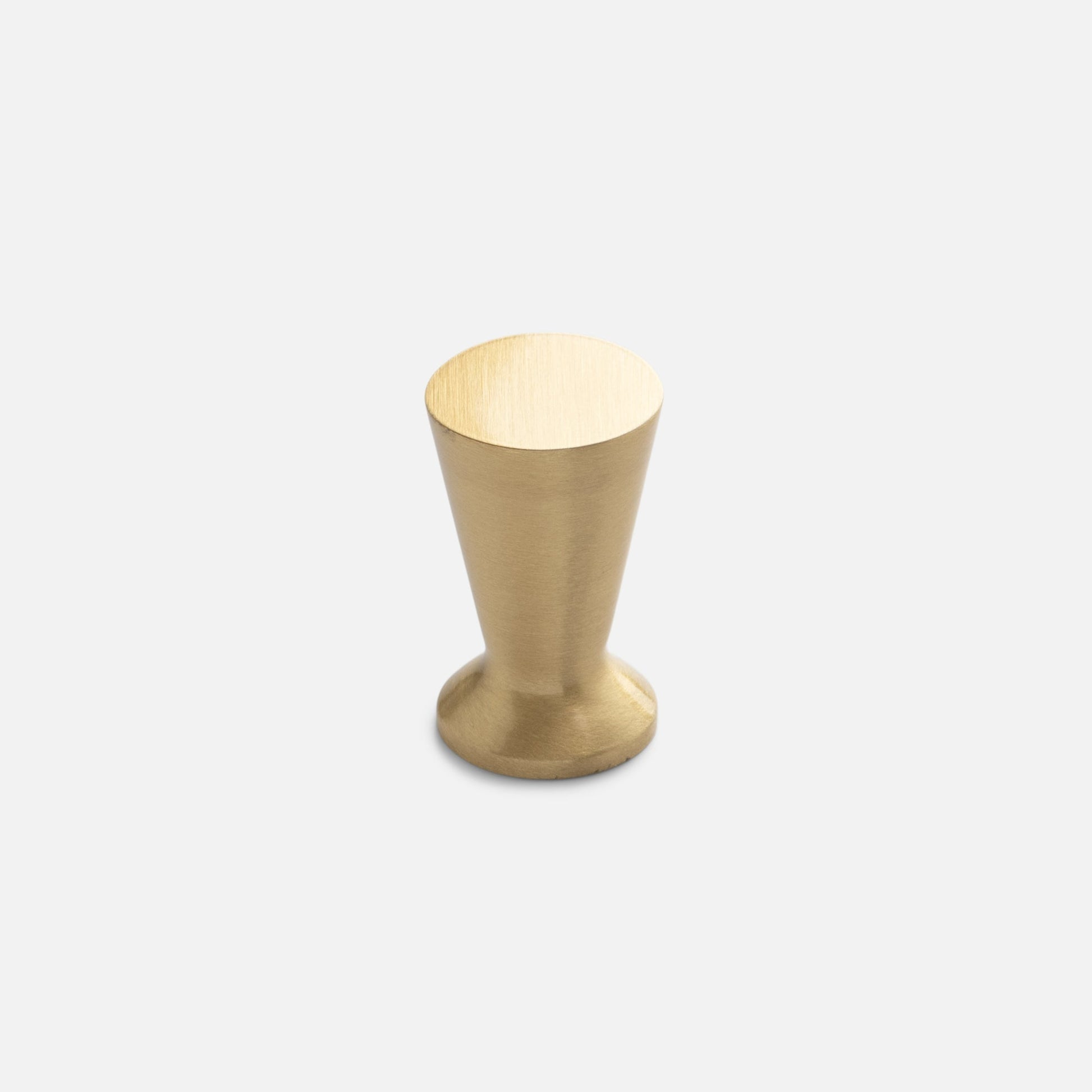 Front view of the Radcliffe Knob in natural brass, showcasing its tapered solid brass design on a light gray background