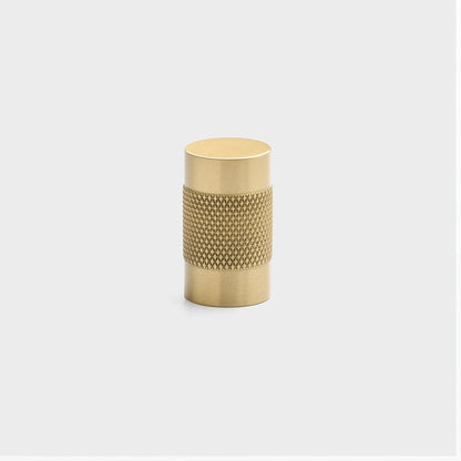 Front view of Knurled Knob showcasing cross-hatched texture in natural brass with a light gray background