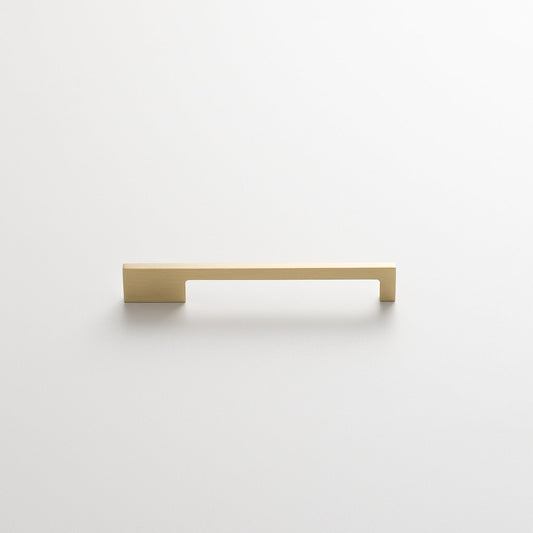 Front view of the Alberta Pull showcasing its thin, asymmetrical brass design against a white background