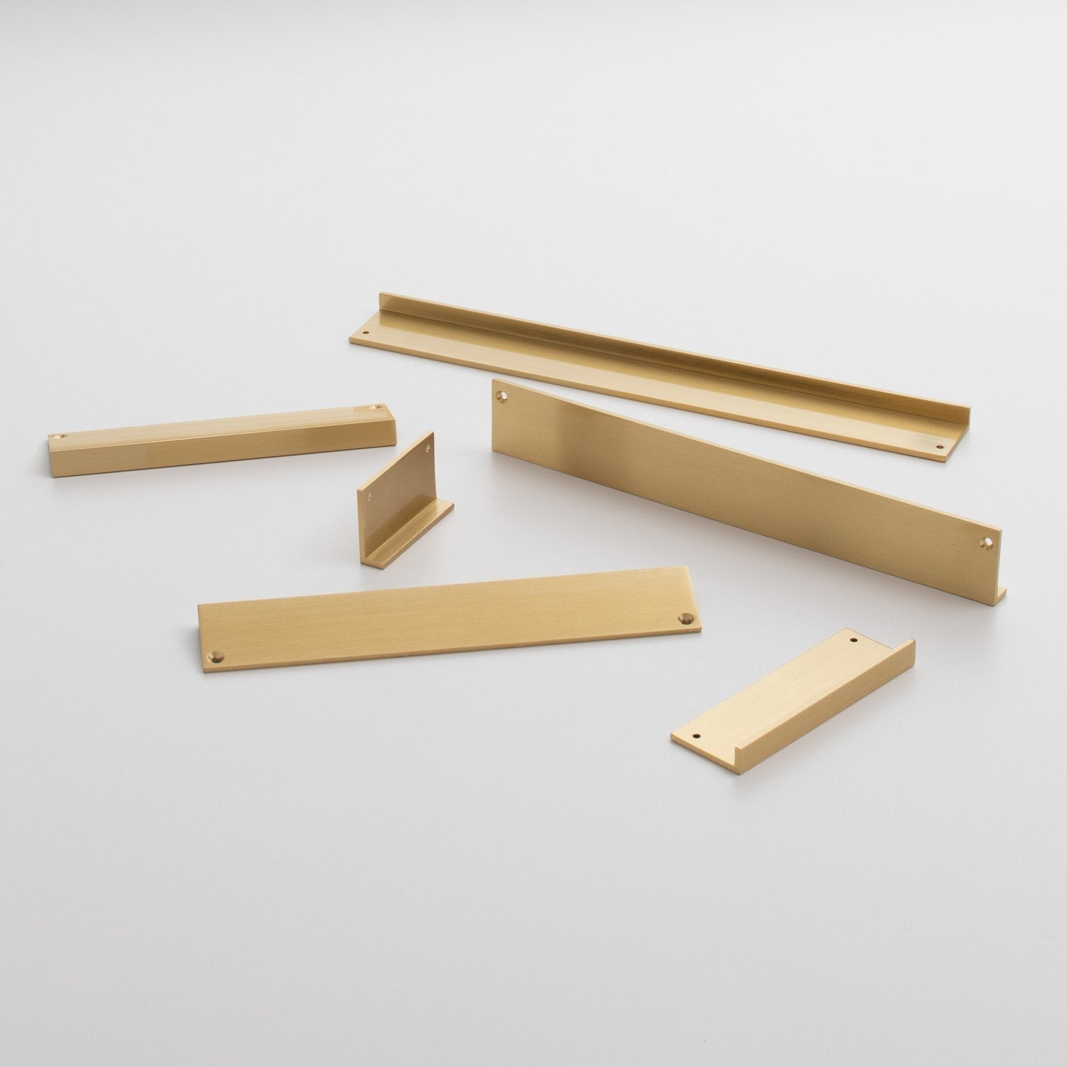 Angled view of Ledge Pull showcasing multiple light wood-colored components with a plain light gray background