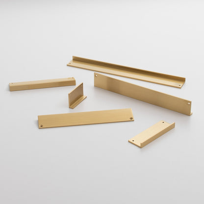 Angled view of Ledge Pull showcasing multiple light wood-colored components with a plain light gray background