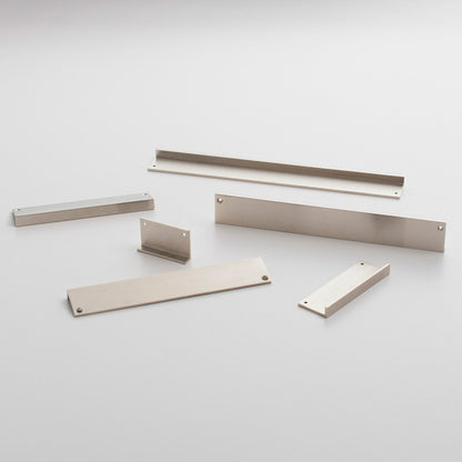 Angled view of the Ledge Pull hardware set showcasing multiple metal components with mounting holes on a light background