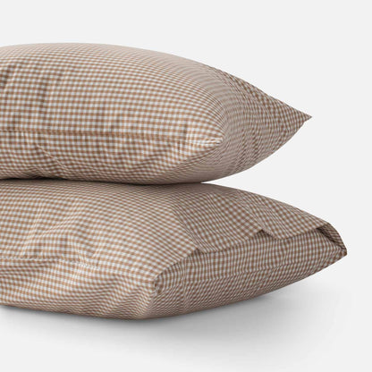 Close-up of two Gingham Pillowcases showcasing a tan and white check pattern against a white background