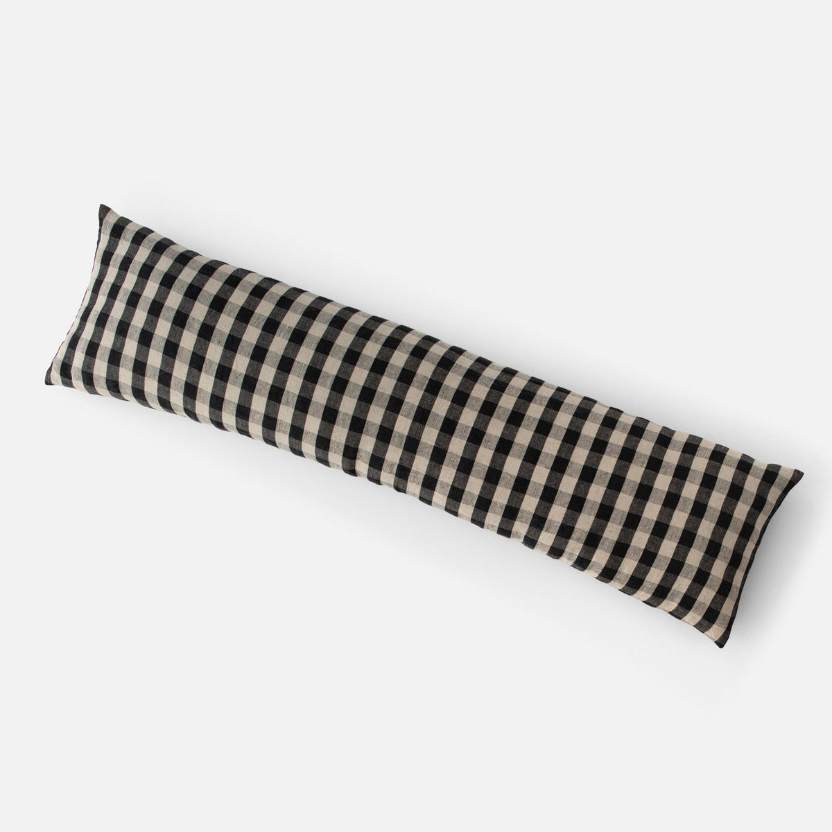 Angled view of Linen Check Throw Pillow showcasing a black check pattern on natural linen with a white background