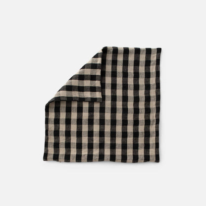 Front view of Linen Check Throw Pillow showcasing a deep black check pattern on natural undyed linen with a white background