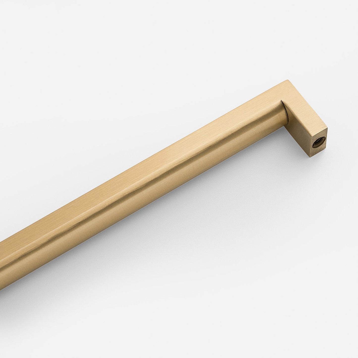 Angled close-up of Edgecliff Appliance Pull showcasing brushed brass finish and squared ends on a white background