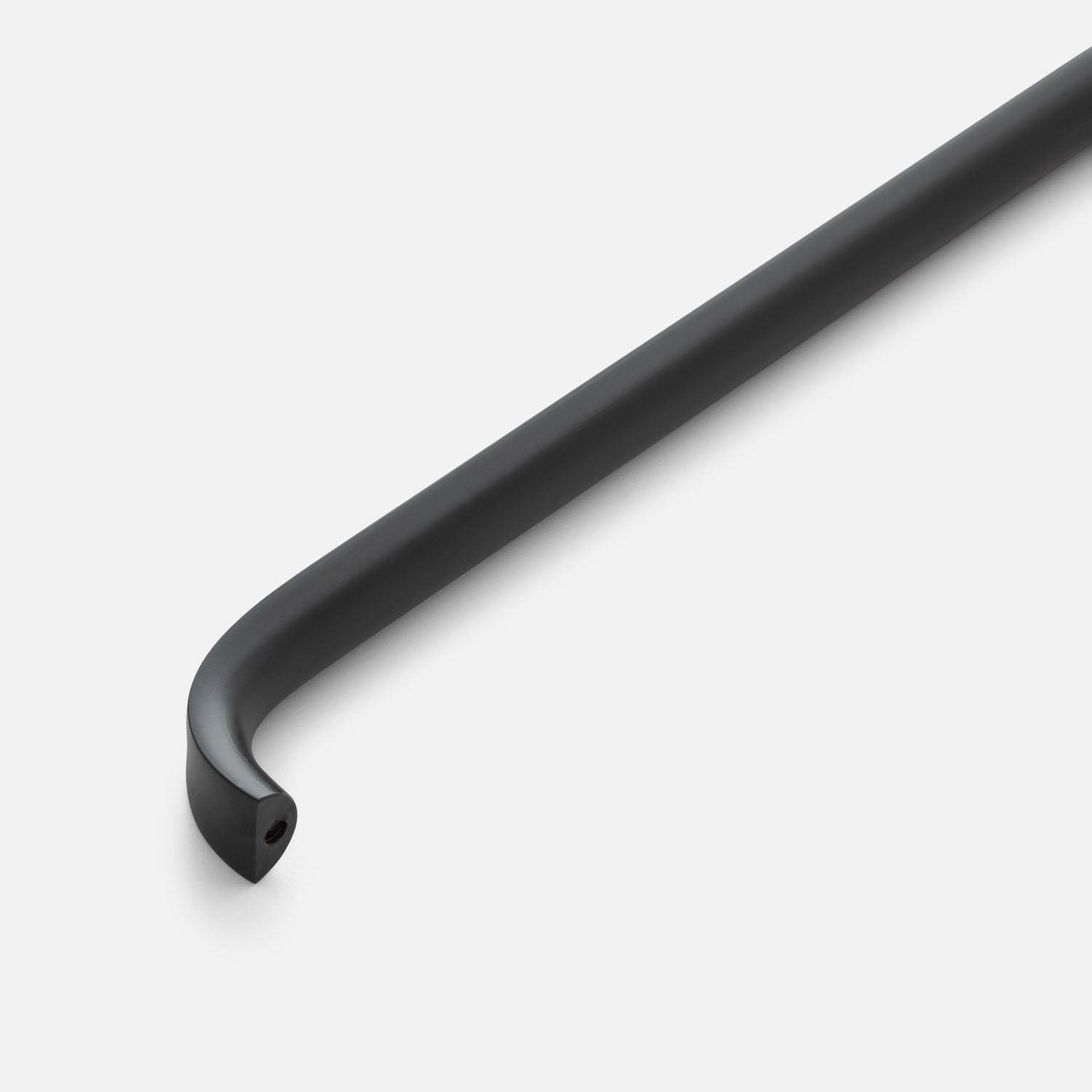 Close-up view of Cascade Pull showcasing its curved black finish with a light gray background