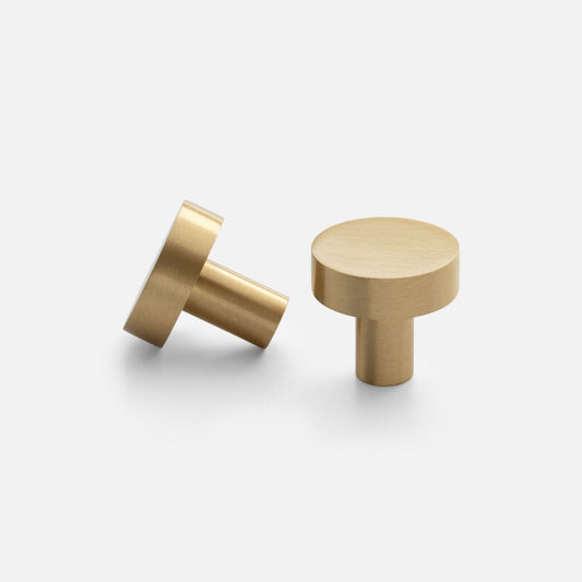 Two views of the Edgecliff Knob showcasing its cylindrical brass design on a light gray background