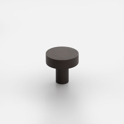 Front view of Edgecliff Knob showcasing a dark cylindrical knob with a wide round top on a white background
