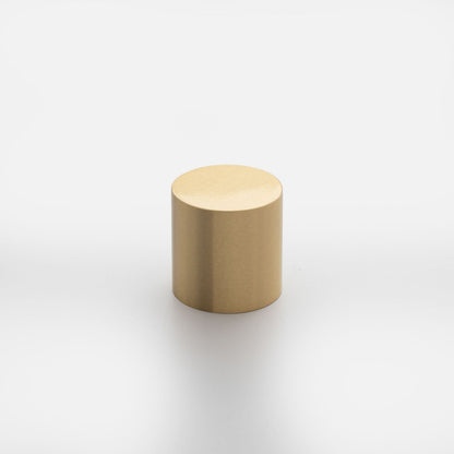 Three-quarter view of Cove Knob showcasing its cylindrical gold finish against a white background