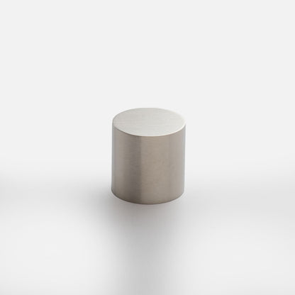Front view of Cove Knob showcasing a cylindrical brushed metal design with a light gray background