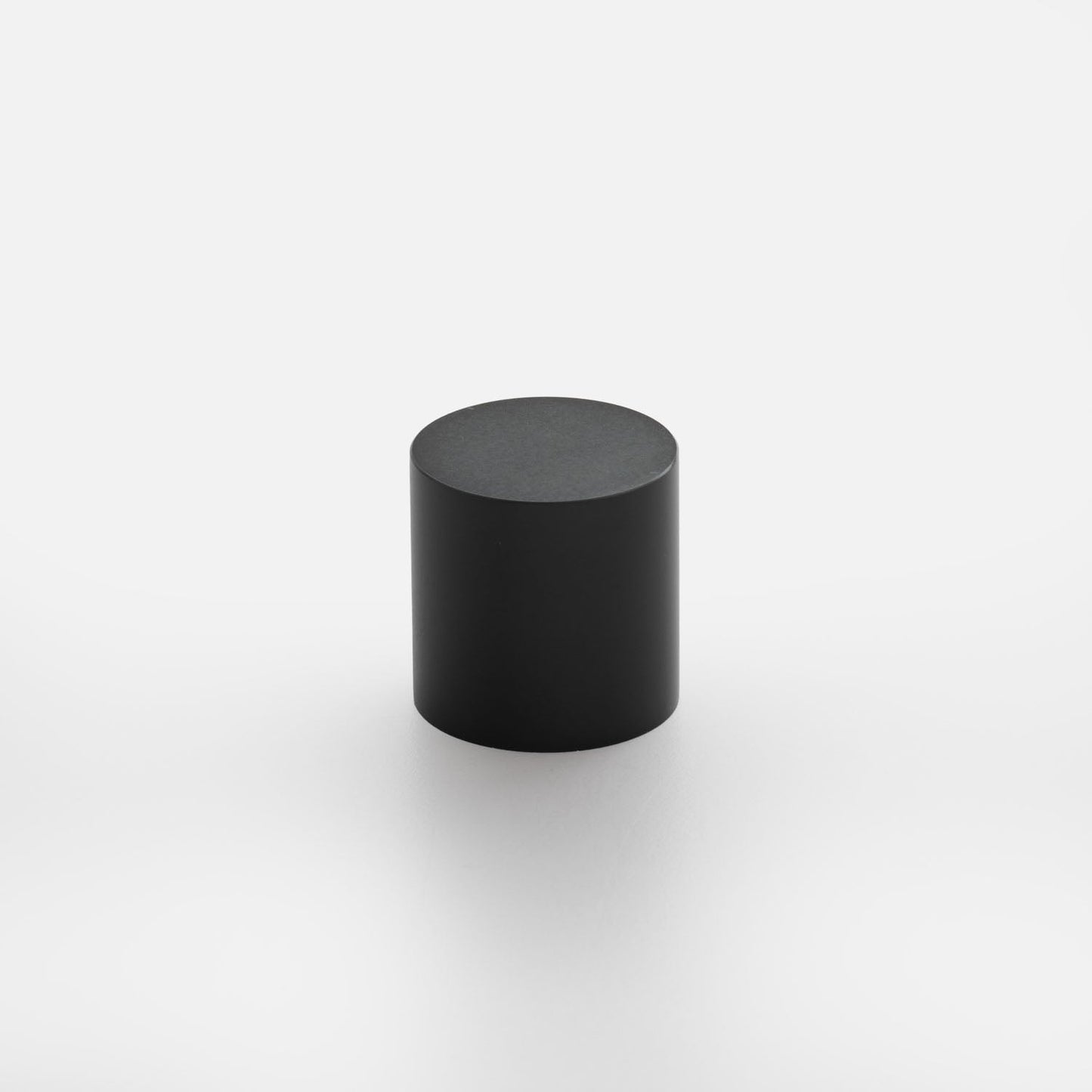 Front view of Cove Knob showcasing its black cylindrical shape with a white background