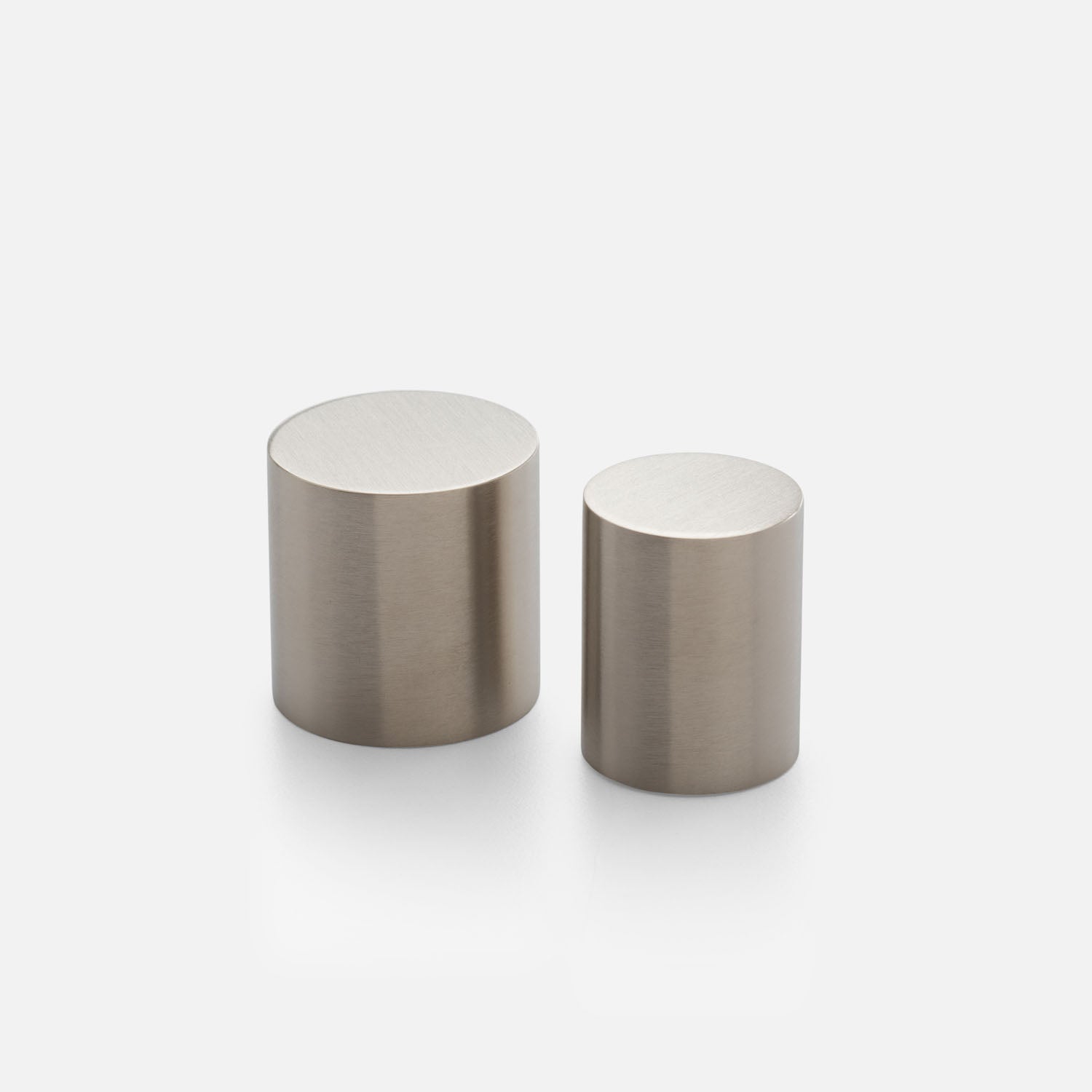Front view of Cove Knob showcasing two cylindrical metal knobs with a brushed finish on a white background