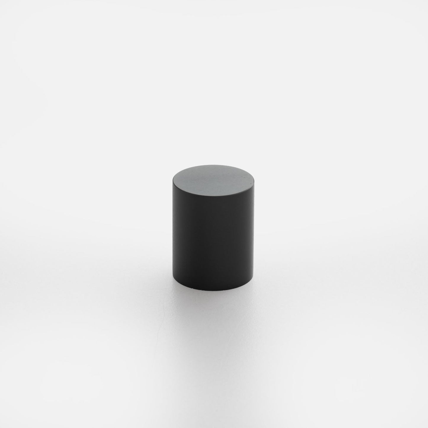 Front view of Cove Knob showcasing its black cylindrical shape against a white background