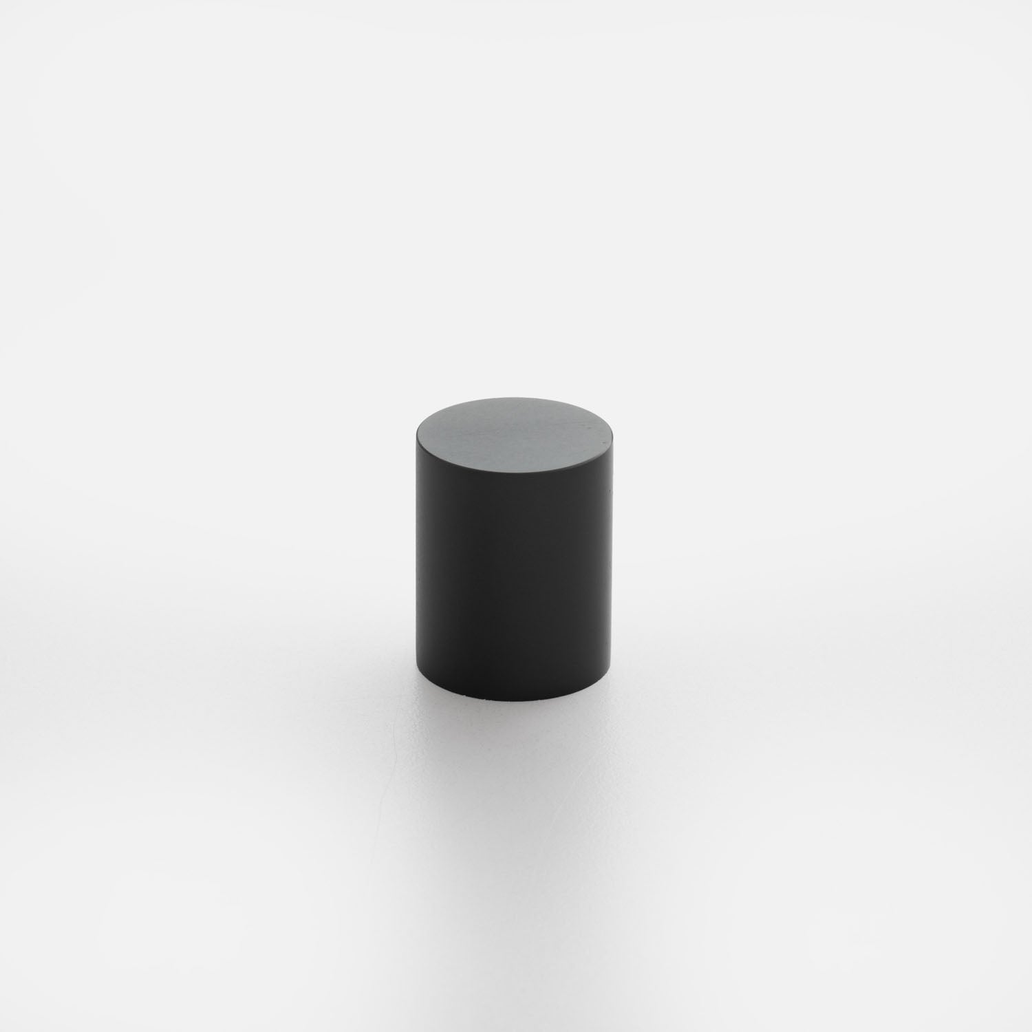 Front view of Cove Knob showcasing its black cylindrical shape against a white background