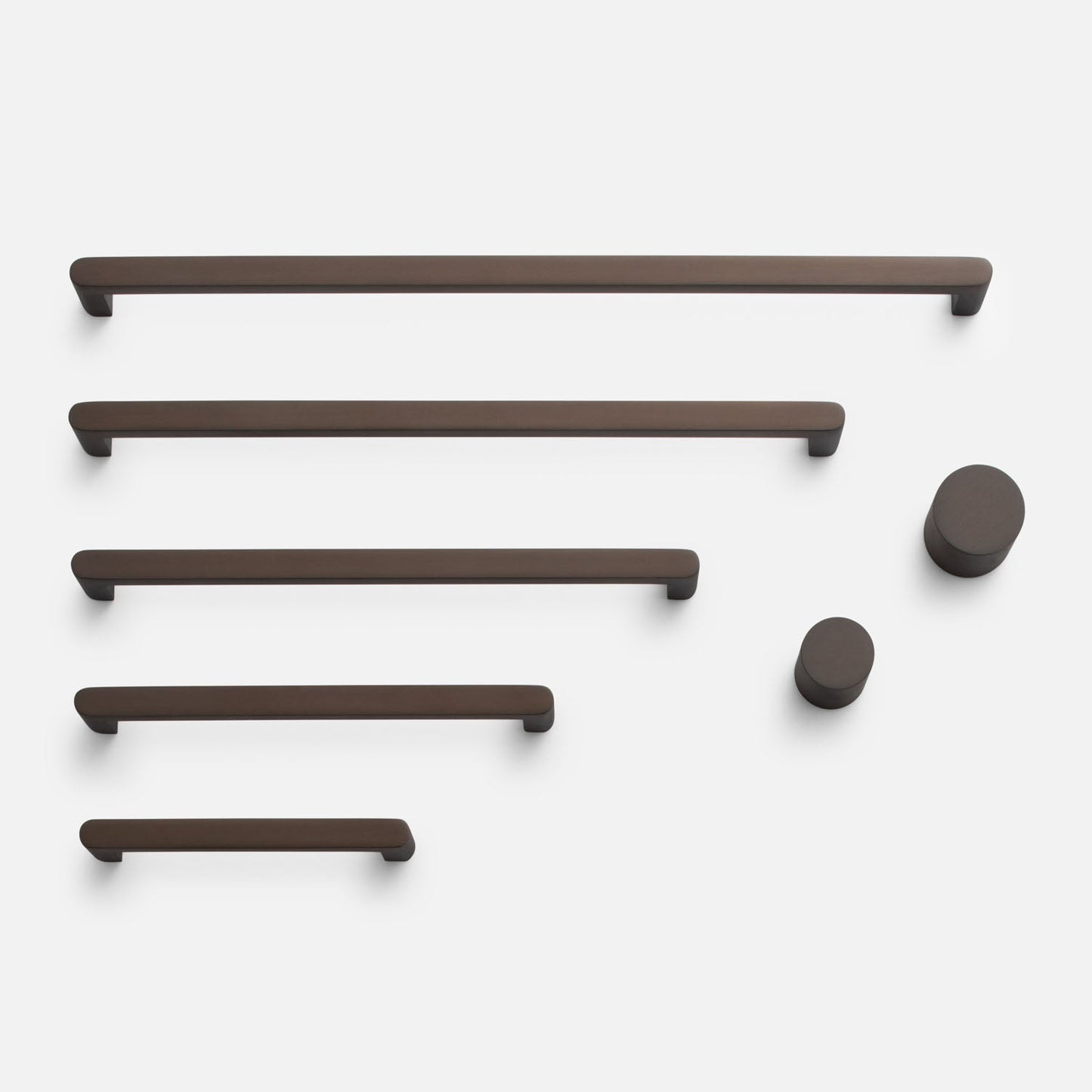 Front view of Cove Pull showcasing multiple bar pulls and round knobs on a white background