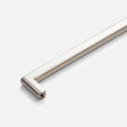 Close-up of Cove Pull showcasing its cylindrical bar and squared mounting end against a light gray background