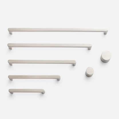 Overhead view of Cove Pull hardware showcasing bar pulls and round knobs on a white background