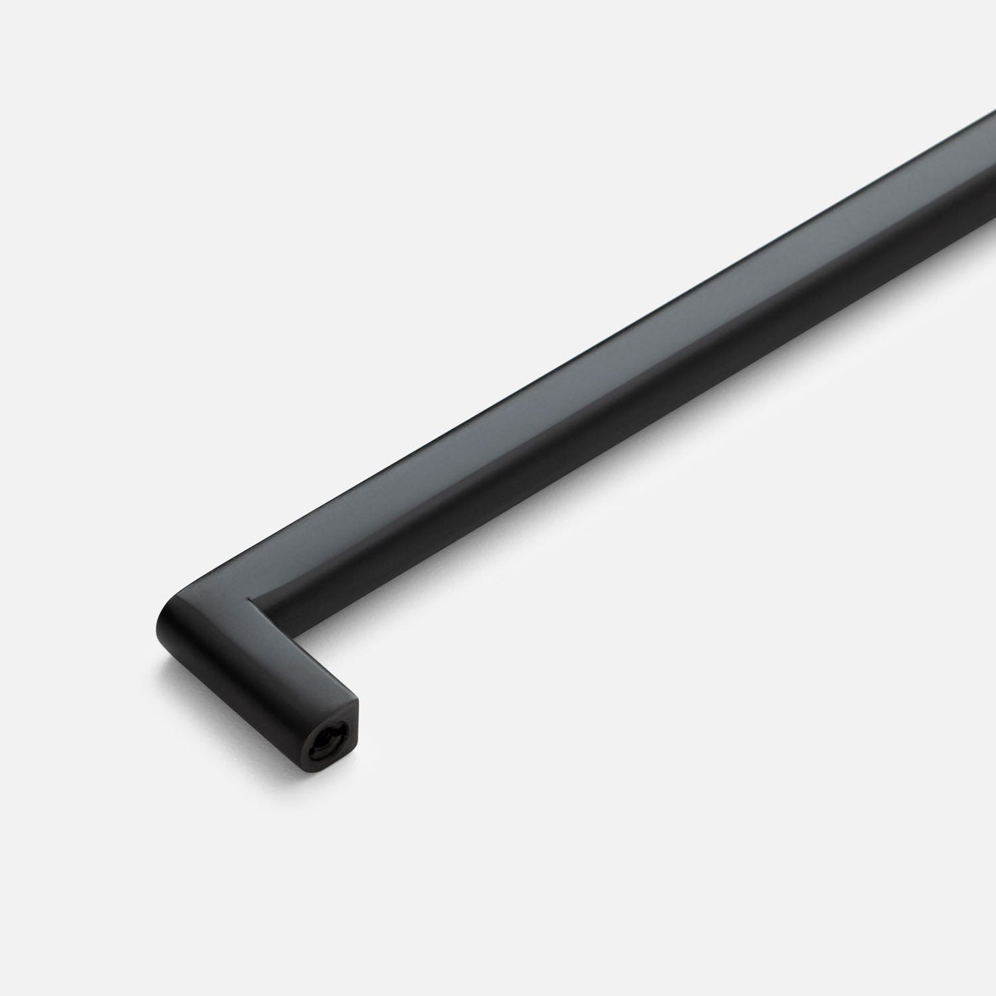 Angled close-up of the Cove Pull showcasing its black finish and rounded rectangular bar with a light background