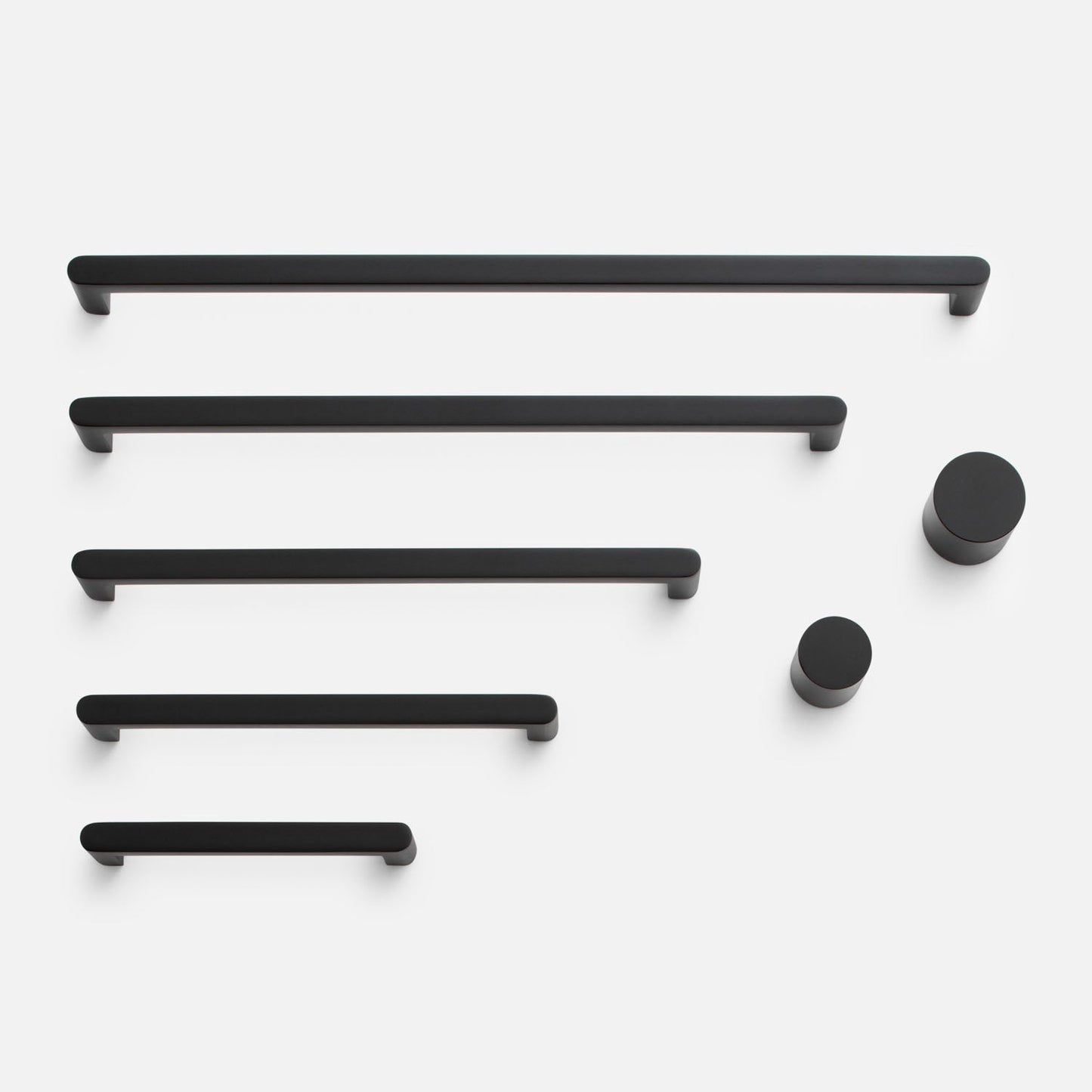 Front view of Cove Pull showcasing black bar pulls and round knobs on a white background
