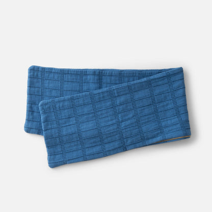 Angled view of Grid Stitch Pillow Cover showcasing blue grid stitching and zipper on a white background