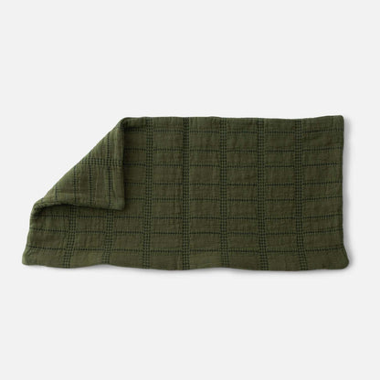Close-up of Grid Stitch Pillow Cover showcasing olive green grid stitching with a white background