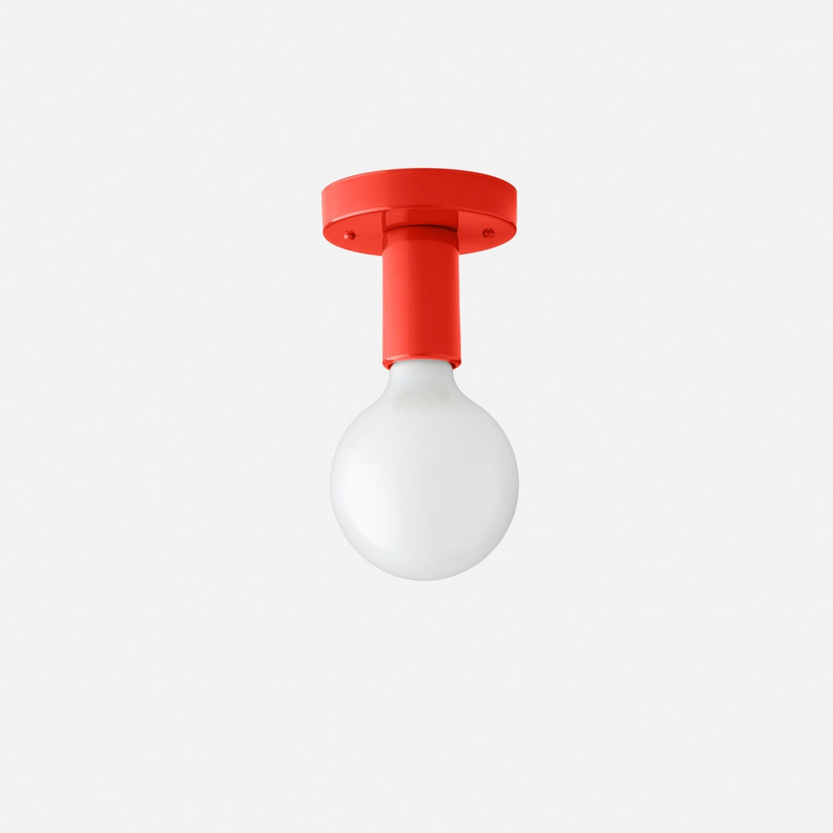 Front view of Cylinder Wall Sconce with a Paprika-Satin cylindrical steel fixture and white round bulb on white background
