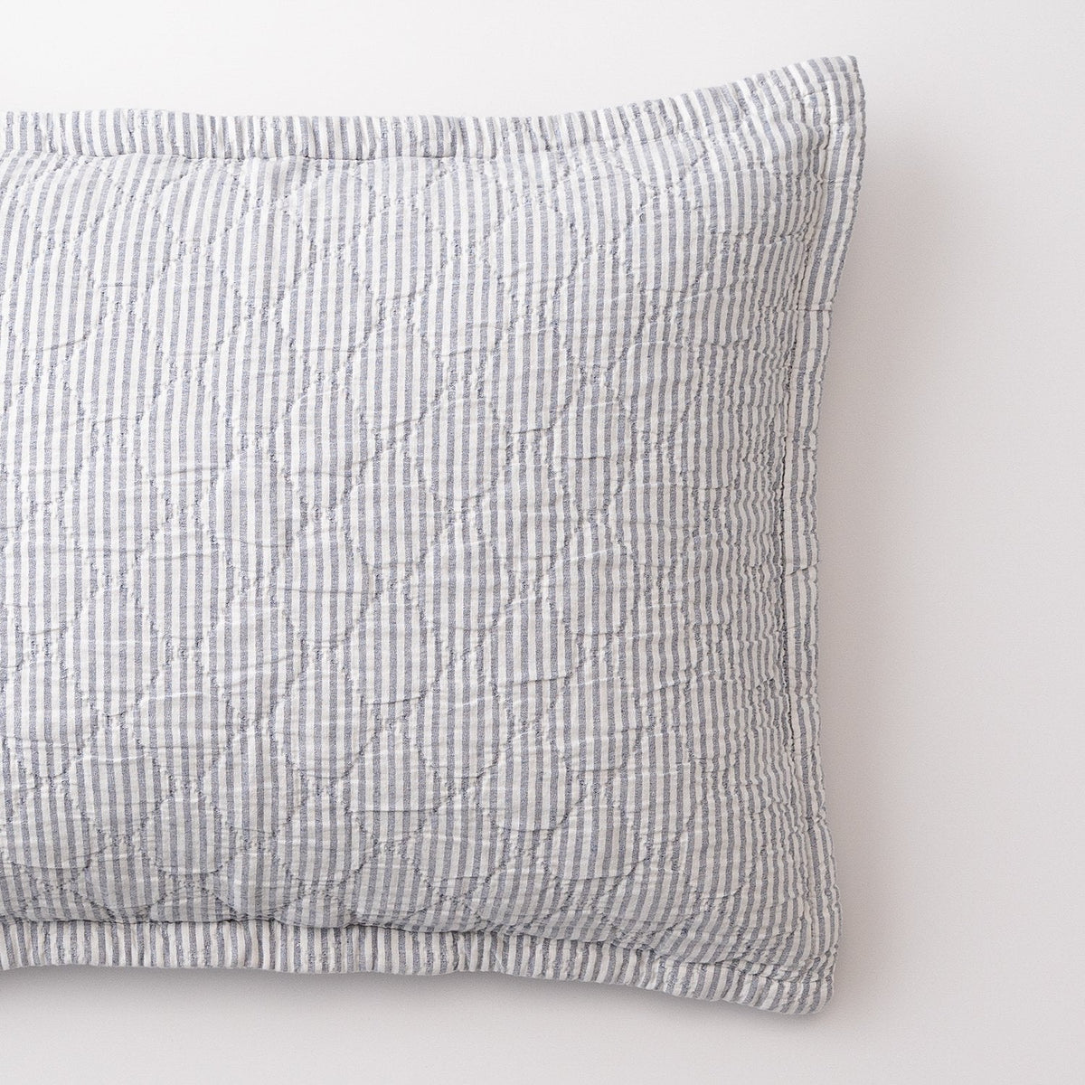 Close-up of Diamond Ticking Sham showcasing gray ticking stripes and diamond pattern with a white background
