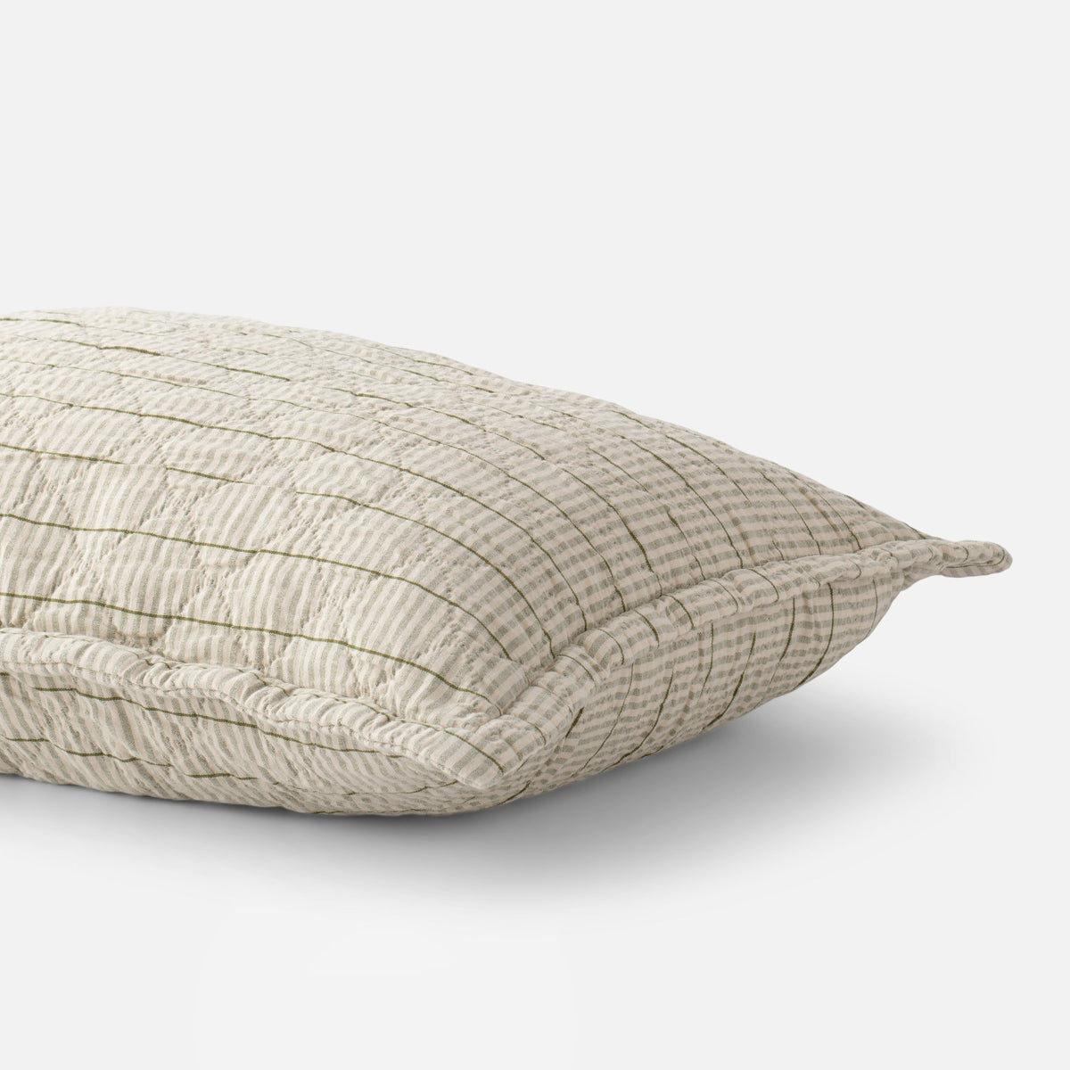 Close-up view of Diamond Ticking Sham showcasing a muted green grid pattern on cream fabric against a white background