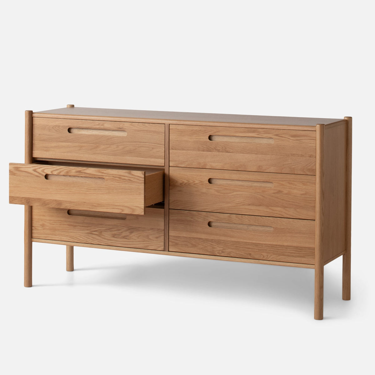 Front three-quarter view of Nora 6-Drawer Dresser showcasing oak construction, six drawers, and pill-shaped handles with white background