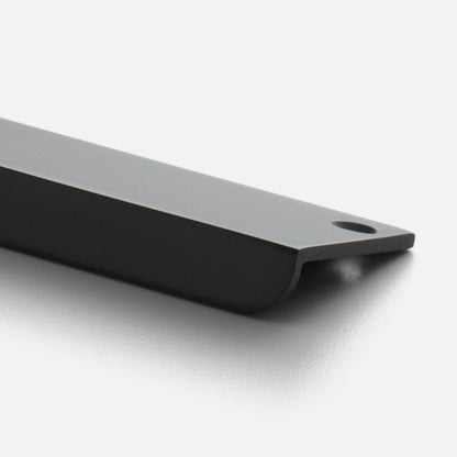 Angled close-up of the black Linn Pull showcasing its elongated rectangular design and mounting hole on a light background