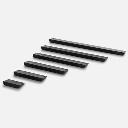 Angled view of Linn Pull cabinet handles showcasing varied lengths, rounded edges, and mounting holes on a white background