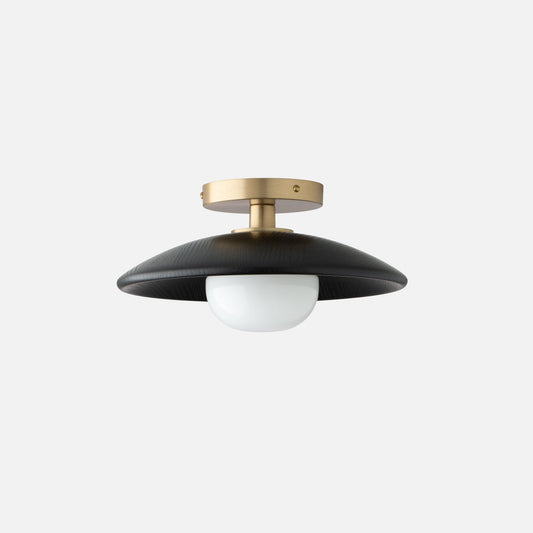 Front view of Atwood Flush Mount showcasing black oak shade, natural brass fixture, and opal glass with a light gray background