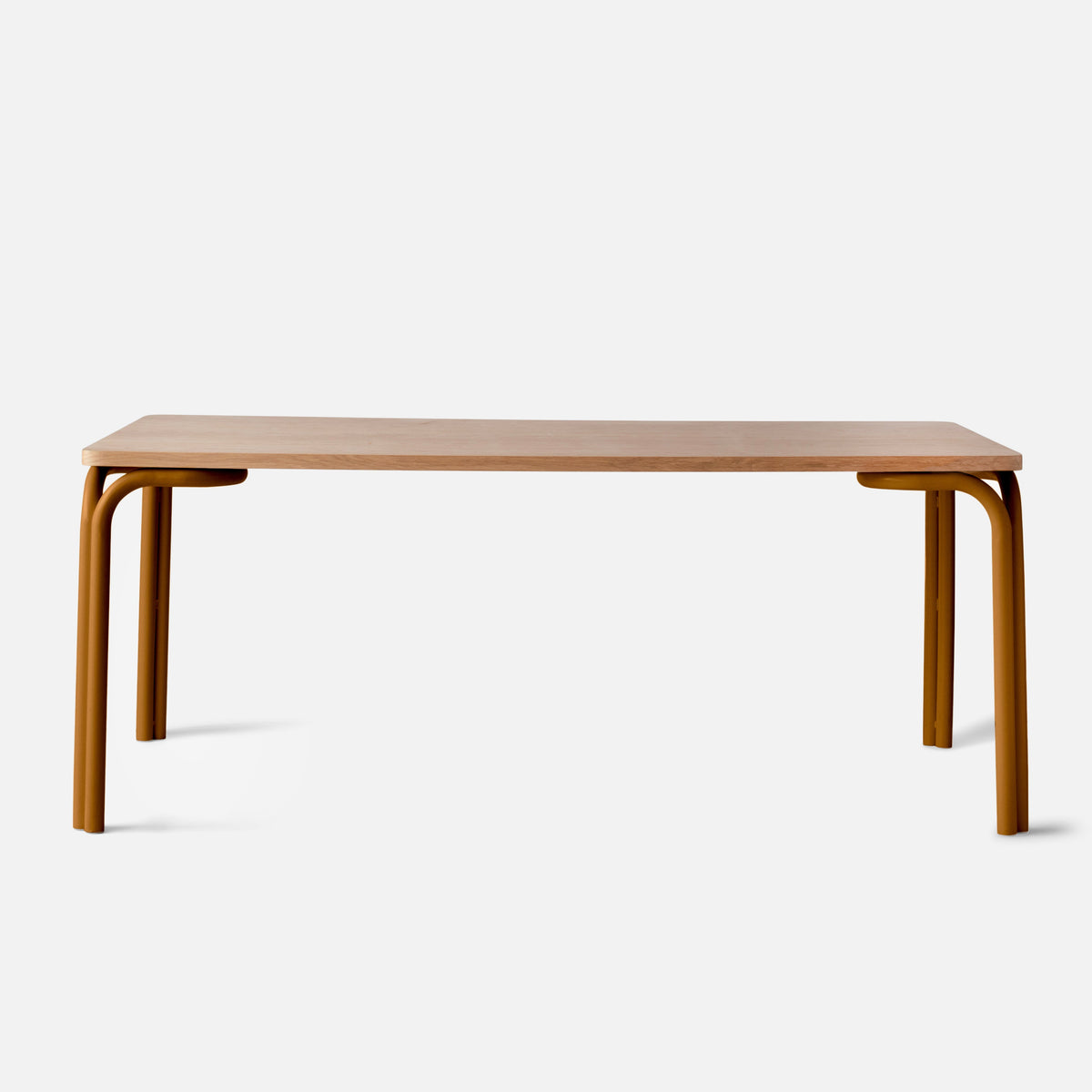 Front view of Forma Dining Table showcasing an oak veneer top and curved mustard steel legs with a white background