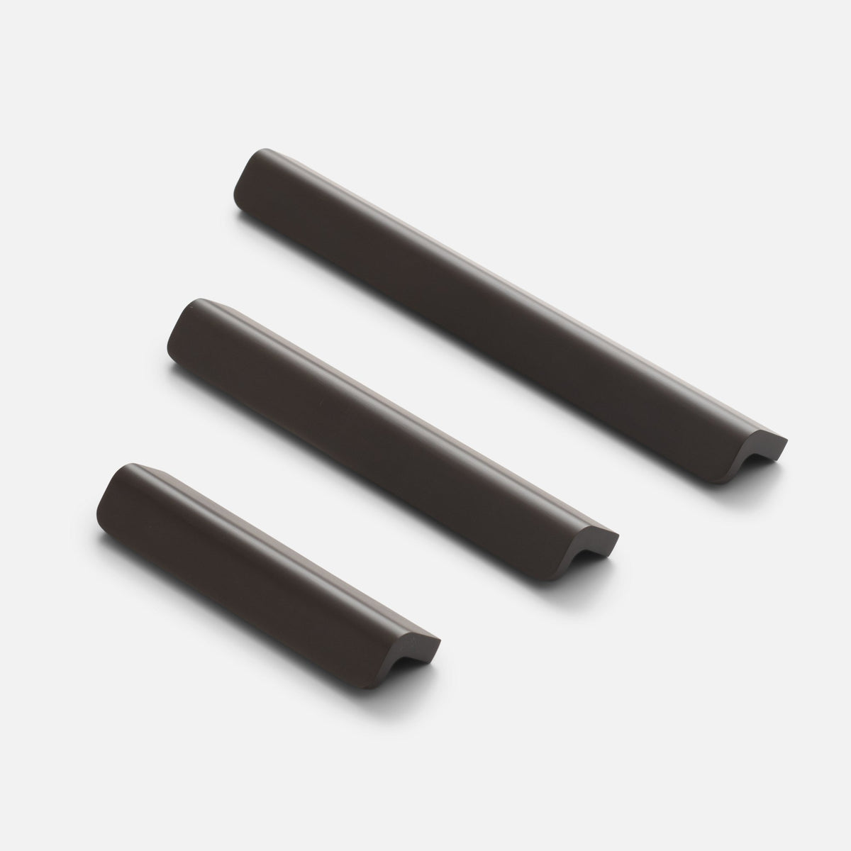 Angled view of Moore Pull in oil rubbed bronze showing three solid brass pulls with curved ends on a white background
