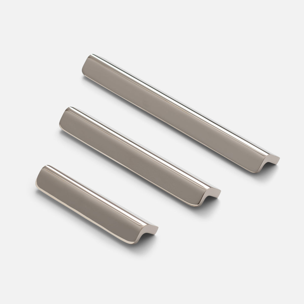 Angled view of the polished nickel Moore Pull showcasing its soft-curved design with a light gray background