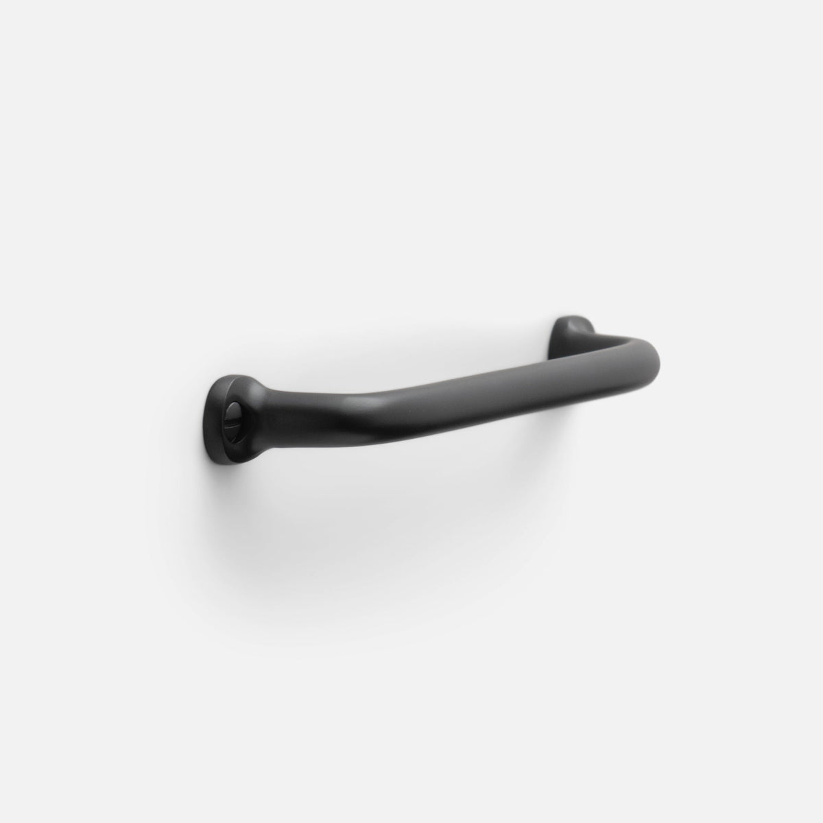Angled view of the True Black Belmont Pull showcasing its gently curved solid brass design on a white background