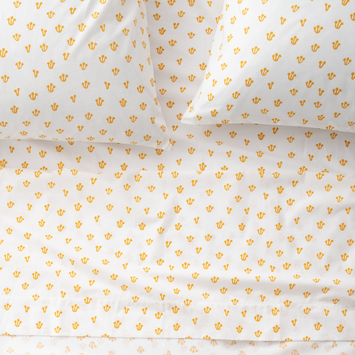 Top view of Thistle Sheet Set showcasing hand-drawn thistle pattern in Alder Green and white on a made bed