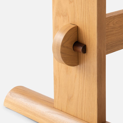 Close-up of the Darrow Dining Table showcasing solid oak joinery and contrasting walnut detail on a white background