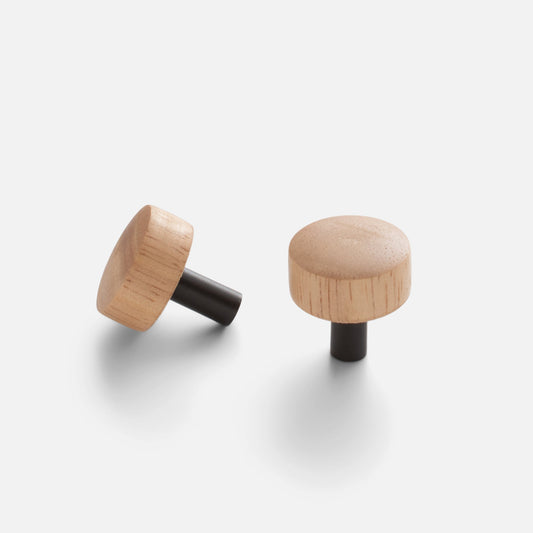 Front and angled views of James Knob showcasing White Oak and Brass construction with an Oil Rubbed Bronze finish on a light gray background