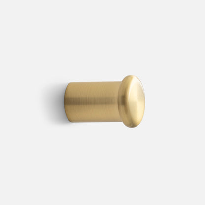Side view of Remy Single Hook showcasing its cylindrical brass form with a white background