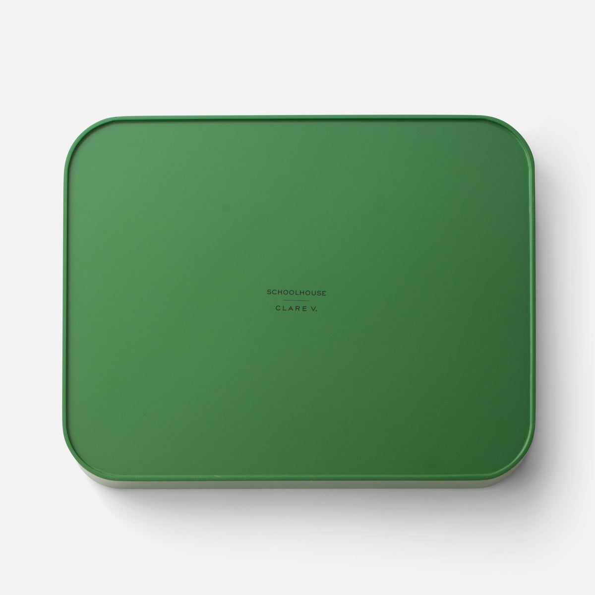 Top view of Clare V Sonia Tray showcasing its green color and rounded edges on a white background