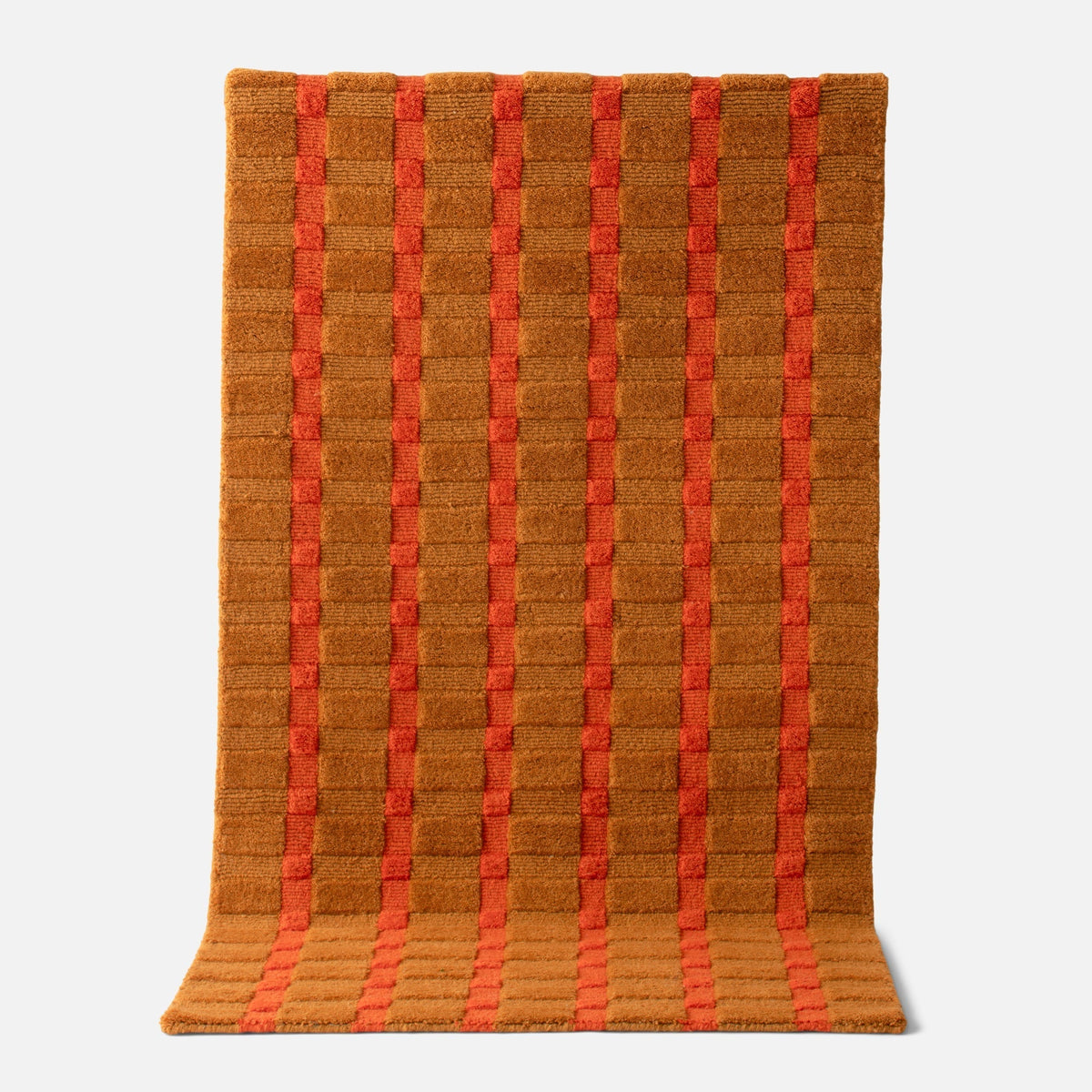 Front view of Ashlar Rug showcasing a brown and red striped grid pattern against a white background